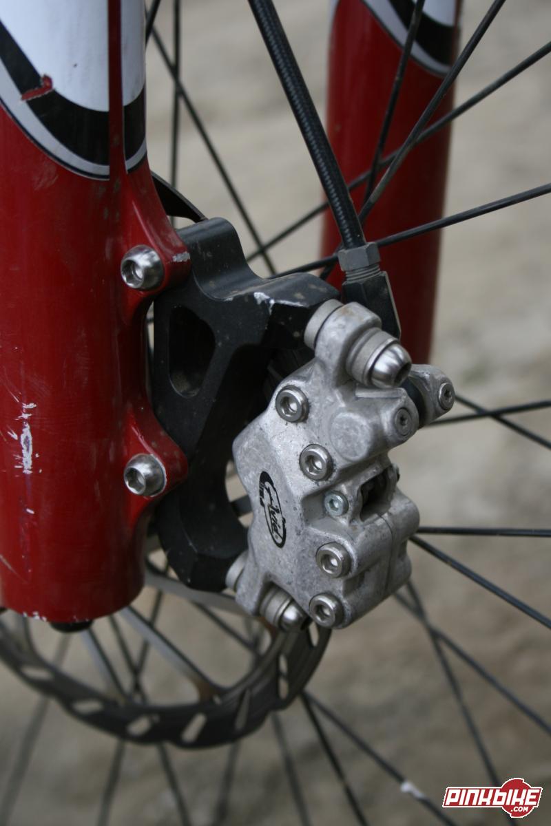 Have a look at the fixing bolts on the caliper and the mounting bolts, yep they are not stock.