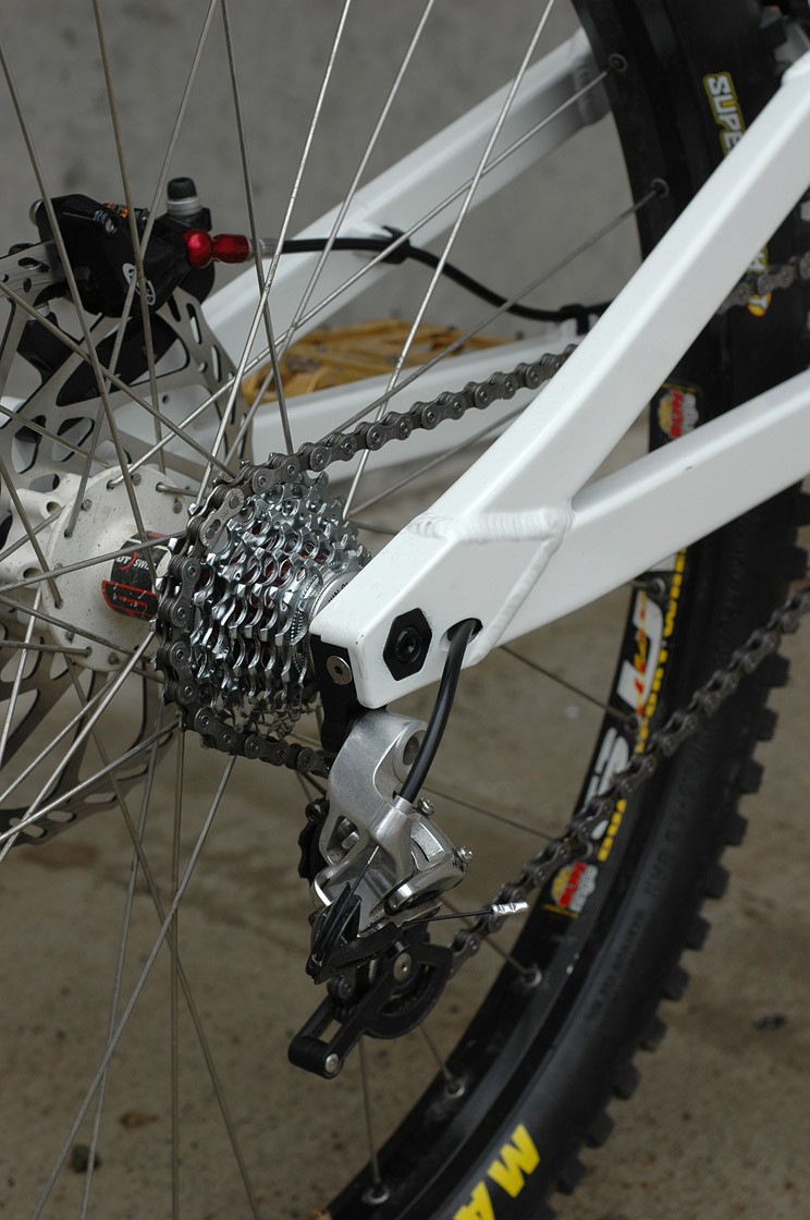 Rear end with internal chainstay cable routing and internally hollowed out dropouts