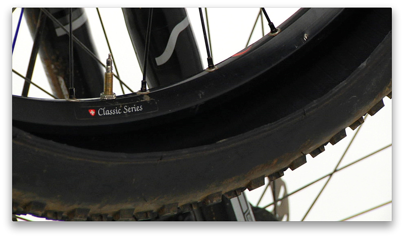 2:31 mark - Hang the wheel off your handlebar or bike stand with the valve in the 6 o'clock position