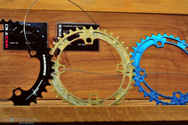 These are Race Face's mega light downhill rings. Mega light as in 40 grams! Machined in their Vancouver facility, these feature a 4 mm cross section as opposed to the standard 3 mm found on most other rings. Options include 32, 34, 36, 38, and 40 tooth, all in 104 mm 4 bolt pattern. There are a bunch of neat colors to pick from Rum Red, Tooth Blue, Bad Ass Black, and Gold Member. All of these rings are reversible, as well as compatible with both 9 and 10 speed setups.