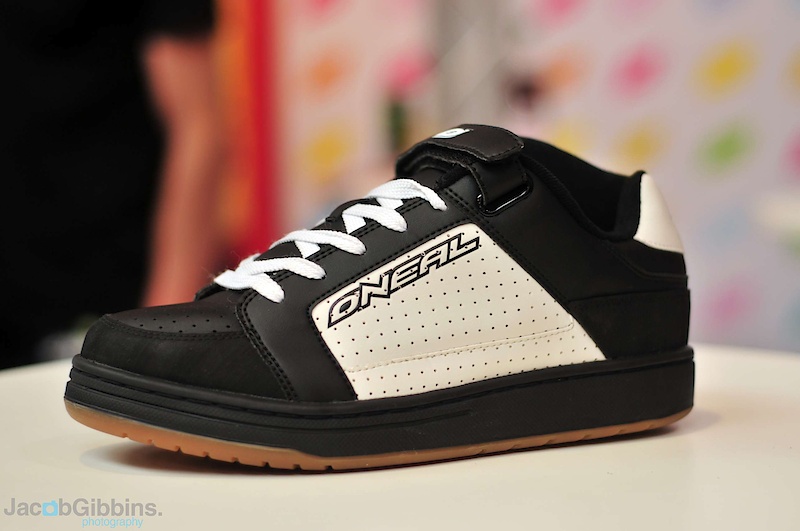 It looks like O'Neal has got you covered from head to toe, literally. This is the new Torque SPD shoe. The flat bottom skate inspired sole features a removable section that allows you to install SPD cleats if that's how you roll. If not, you can also run them as standard platform pedal shoes as well. There are some riders out there who prefer a stiffer sole for use with flat pedals, myself included, and these could be the bee's knees for that. Up top you'll find a traditional design that won't have people staring at your kicks like they would when wearing some of the more moon boot-like shoes out there. Skate styling, but functional as well. Backing up the laces is a Velcro strap to add a bit of extra security. Riders who are prone to catching their ankle on the crankarm, a most painful experience, should note the raised inner protection designed just for that.