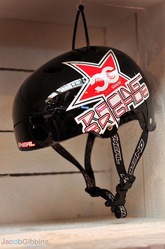 Attention dirt jumpers and piss pot wearers: this is the new signature CG Dirt Lid helmet from O'Neal. How is it any different from other DJ lids? The easy to spot difference is the CG logo on the side, ideal if you are not shy about letting the other boys at the jumps know who you're a fan of. It also felt remarkably light in our hands, despite the protective, hard outer shell. While a lot of DJ lids have a few overly simple circular holes cut in the top to let a bit of air in, the Dirt Lid actually uses 14 proper vents to get the air flowing better than you'd usually find on this type of helmet. Proper wide straps hold it in place as well. There are three sizes available and you can check out the O'Neal site to see the other color options.