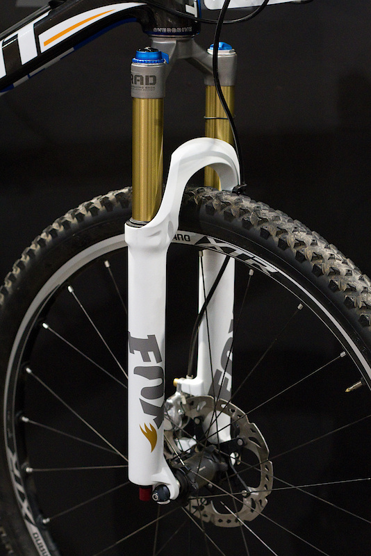WOW. While checking out the DOSS post, Fox's Dan Robbins casually mentioned that I may want to check out something that was on display at the front of the Fox booth. You're looking at a one piece crown and tapered steerer that is made from a single piece of titanium. I don't think that it gets much cooler than this. While not saying that they will never have a similar unit in carbon, Fox does take some issues with using such a material for this point on the bike. I was told that by using titanium they were able to keep the same stiffness numbers, but shave 90 grams from the fork in one fell swoop. This is Adam Craig's personal bike that is equipped with the first ever completely built Float Ti fork. Start off with the one piece titanium steerer and crown, throw in some Kashima coated stanchions, add some matte white lowers, and you have what is possibly the raddest XC fork ever put together.