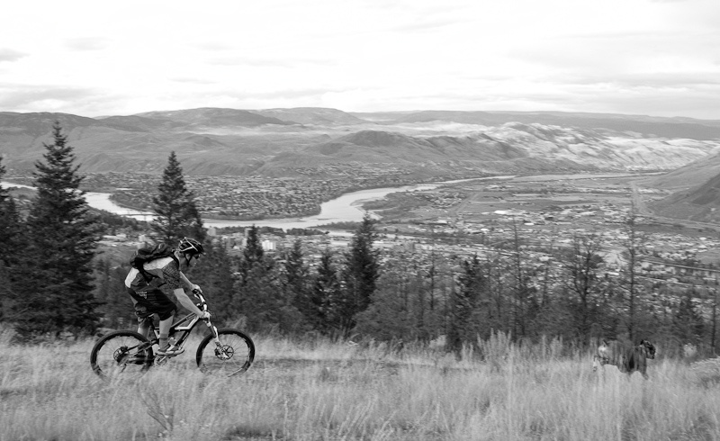 Matt and the Bicycle Cafe shop dog, Haiden, high above the city ripping single track. -Photo by Tyler Maine