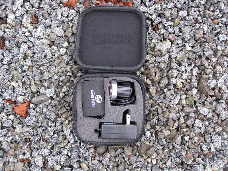 <span style='font-size:16px'>The Gemini Titan's Protective Travel Kit. The extension cable fits inside on top of everything else, but the helmet mount and head band will not fit.</span><br><br>The light is a Seoul Semiconductor P7 with a claimed lumen rating of 900, and a run time of four-plus hours. In testing the Titan appeared as bright as any Magicshine, or about as bright as the Cygolite Mitycross 400, but less bright than the Light & Motion Seca 400. Actual run times on a fully charged battery averaged between 3h 40min to 3h 50min. The light weighs in at 120g, and is water tight (as discovered when dunked into a muddy pool by accident during a rainy night ride). The front lens is removable, and the reflector may be lifted out. The cable exiting the light measures 13cm (14.5cm  on a second light), the 1m extension cable 98cm, and the battery cable is 19cm for 1.3m of potential cable routing. A small Philips screw holds the light to a mounting bracket, there is some give in the mount, and you might want to add a dab of loctite to prevent the light from loosening over time (the second light was much more secure with no wobble). The light housing is aluminum and acts as a heat sink for the light, and becomes warm to the touch with prolonged use.