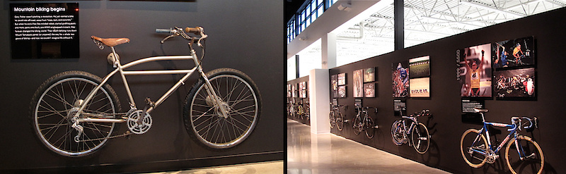 <span style='font-size:18px'>History on display</span><br><br>Trek proudly puts a massive emphasis on moving forward and using the best technology available, but it's good to never forget where you came from. The first thing that you see upon entering the building is a large display, including two glassed in bikes, one of which is one of the first steel touring bikes that was welded in the original Trek building - a big red barn. The lobby walls are covered in photos and memories of Trek's founder, Richard Burke, and other important figures in the company's past. Leaving the lobby through a set of large glass doors puts you in the above room, a large open expanse with opposing walls adorned with standout bikes from the past. One of Gary Fisher's very first clunkers (<I>left</I>) is bolted solidly to the wall. This beast is said to weigh about 75lbs, sports drum brakes front and back, and most importantly, had been fitted with a rear derailleur by Gary himself. The mountain bike wall also had the once futuristic Y-bike and some more current race machinery on display. The opposite wall was mostly occupied by bikes that Lance has ridden to victory, and was arranged by technological advancements, not chronologically.