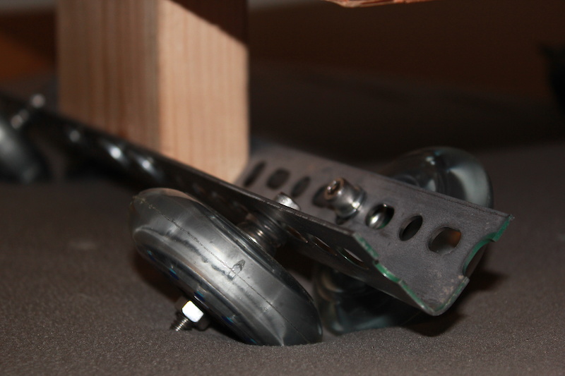 Wheels mounted to metal, metal mounted to wood.