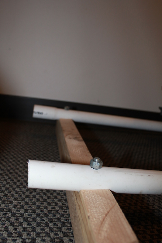 The PVC pipes mounted to a wooden frame that keeps them from rolling around.