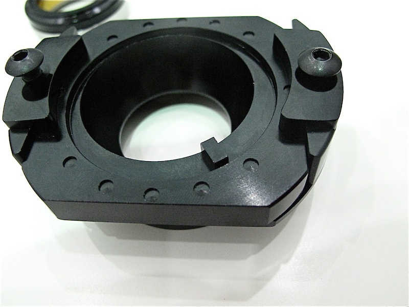 The complete upper assembly. Angle adjustments are made by turning the tab on the bottom right hand corner, which turns the offset gimbal and alters the bike's steering angle. Once adjustments have been made, you lock them in place by tightening down the two clamps on either side of the sliding plate. These, combined with the pre-load from tightening your headset, keep the unit from shifting.