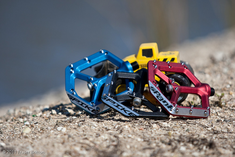 Spank's Spike pedals received quite a bit of attention during our preview article due to their unique looks and ultra thin 12mm profile, but there is more to the story than those two facts. The large platform spins on an oversized inboard sealed bearing and a thin outboard bushing that allows the pedal to have such a slim profile, while the leading and side edges of the body are shaped for more clearance and to glance off of impacts.<br><br><span style='font-size:19px'>Spank Spike pedal details:</span><br><br>- Thin 12mm pedal body<br>- Large 90 sqcm platform<br>- 19 adjustable pins per pedal<br>- Cold forged and CNC optimized body<br>- Chamfered leading and side edges for improved impact deflection and more clearance<br>- Full compliment sealed inboard bearing<br>- Reduced diameter Igus outboard bushing<br>- Heat treated steel pedal axle<br>- Proprietary 'Spank Friction Seal' for durability and maintenance<br>- Reduced Q-factor<br>- Sub 400g weight (<i>claimed</i>) with cromo axle and alloy platform<br>- MSRP $125 USD