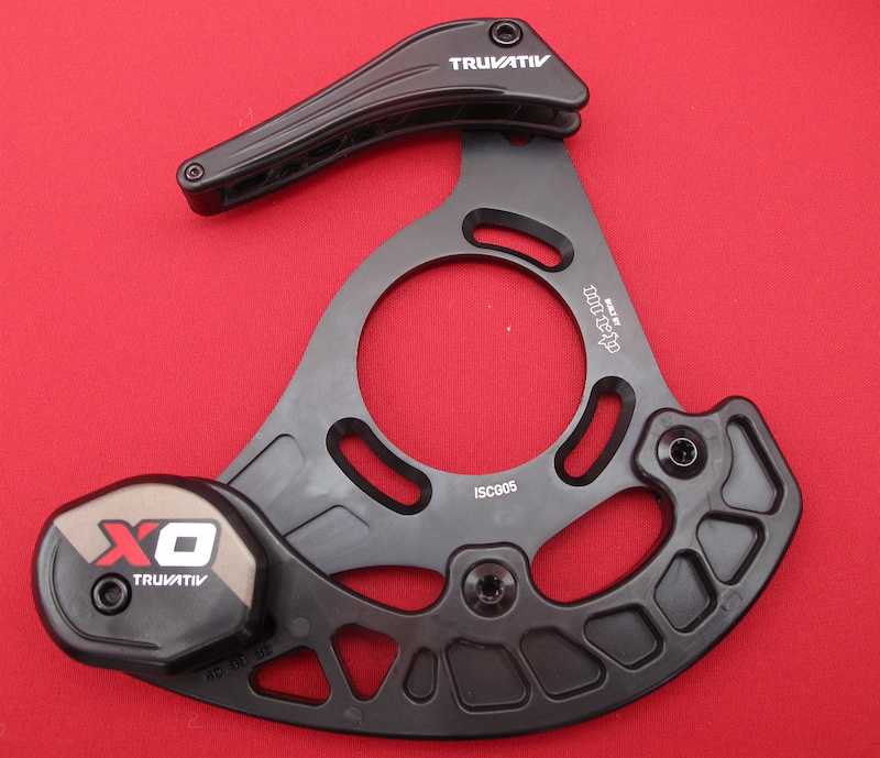 You may have seen photos of Truvativ's XO guide a while ago, but now it is official. It is obvious to see that the new XO guide looks very much like an MRP G2SL - that is not a coincidence. Given that chain guides play such a vital role in how a bike's drive train performs, both MRP and Truvativ feel that it only makes sense to pool their resources.<br><br><span style='font-size:19px'>Truvativ XO chain guide details:</span<br><br>- Integrated replaceable skid plate design<br>- Sealed bearing pulley wheel integrated into skid plate<br>- Aluminum back plate<br>- Available in BB-Mount, ISCG or ISCG 05 mounting standards<br>- Models to fit 32-36 tooth rings and 36-40 tooth rings<br>- Black and white color options