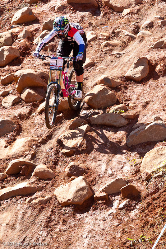 Defending World Cup champ Sabrina Jonnier makes her way through one of the last rock gardens on track on her shiny pink Rocky Mountain.