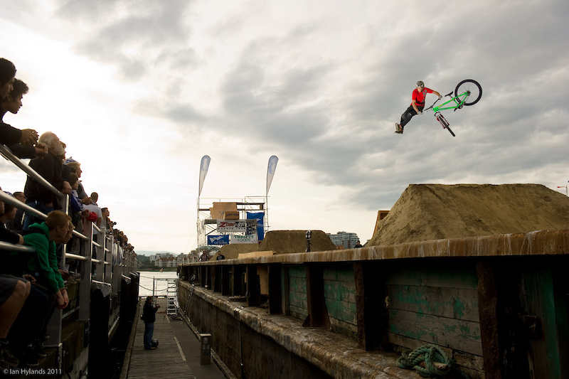 Luke Fulton with nice looking stretched out tailwhip on the second double on the barge.