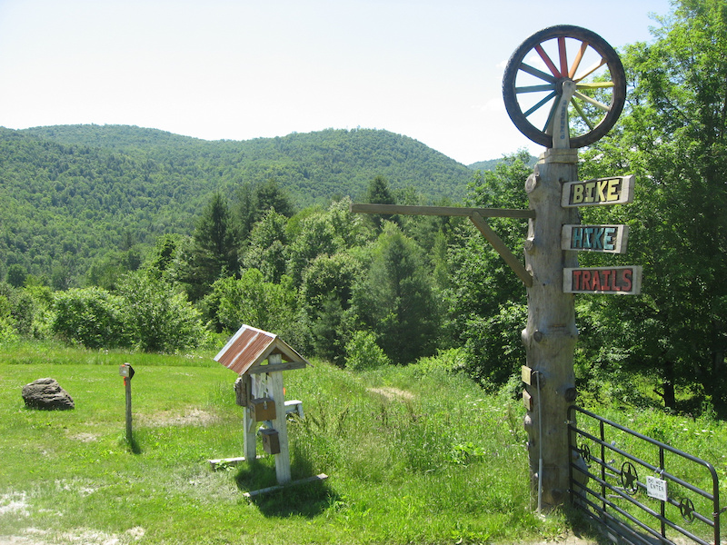 The trails start right here and the majority of the network is on the hill in the background.