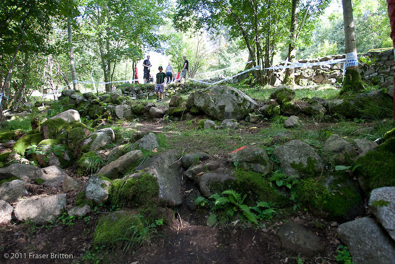 3 rocky ledges in the trees. Jump the first one double up the second and third.