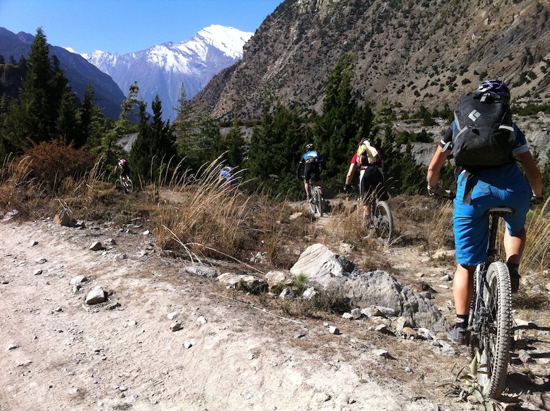 Heading downhill from Marpha to Tatiopani on the east bank of the Khali Gandaki. Part of Dhaulagiri at 8 167 metre the 7th-highest peak in the world is in the background. photo Ian Merringer