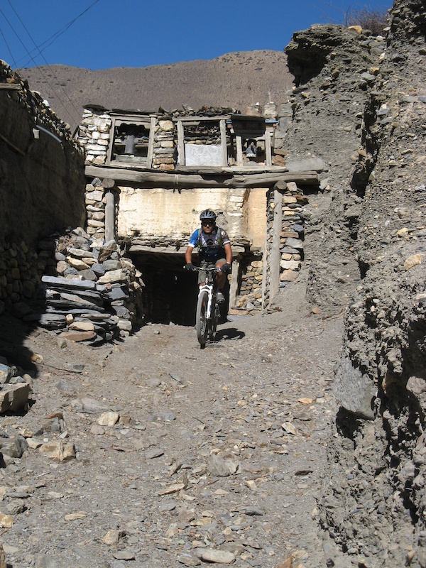 Mandil Pradhan head Nepal guide rides out of Falyak s main gate. photo by Ritchie Williams