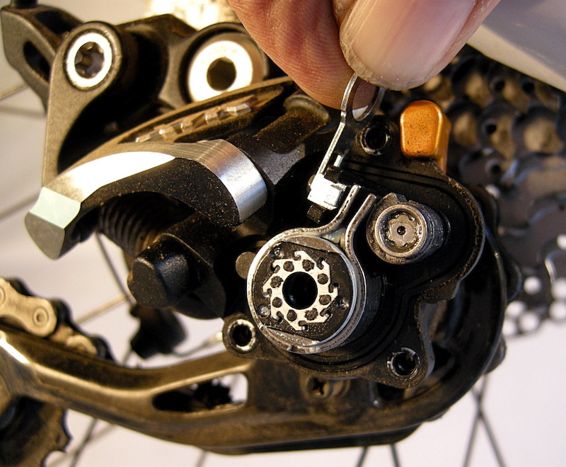 Use the adjustment wrench to tighten the small hex screw clockwise to add tension to the friction band. A fourth turn makes a noticeable difference.