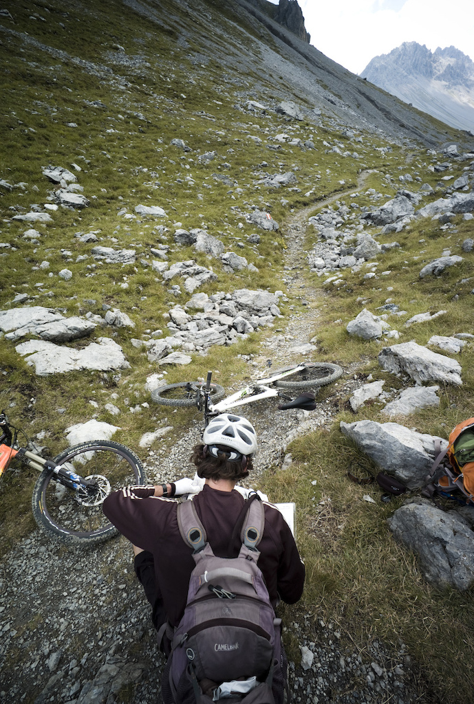 <span style='font-size:12px'>The AR route is not signposted as clearly as we'd have liked and with so many trails scoring the mountainsides, regular map-reading breaks were a must.</span><br><br>A tour is only a tour of course if you return to your start point, meaning we need to reach Tirano to take the Freeride Express back to St Moritz. Marcizo, our enthusiastic host at the refuge points out a great singletrack descent back to Santa Catarina where we can take a cable car to 8000 ft before descending to Tirano. Well rested and over-fed, we pedal out of the refuge in the shadow of an almighty glacier, its ice glowing blue in the early morning light. Perfect high mountain singletrack and a cablecar uplift put us in good spirits as we trace our route to the Paseo dell'Alpe pass, but when the trail eventually leads out onto 4x4 track we become lured away from the easy descent to Tirano by a small trail heading off over a makeshift bridge and into the forest. 'Okay, if it turns downhill in the forest we'll follow it' we agree, before finding ourselves lunging down the trail as it swoops through mossy old growth forest.