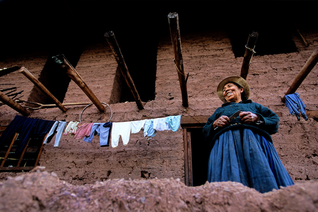 This lady was living on the side of a trail in this very authentic looking mud home. I like the old bike rim hanging on the wooden beams that spanned through the entire house. Maybe it was a childs toy or a tool used for some daily chore. In her hands were potatoes that she was peeling as she talked.<br>The women I noticed are always working with their hands. It's really common as they are walking to be spinning wool, which makes sense because some people are walking 10 hours a day. Yeah 10 hours! I was told some live high in the mountains and have to walk to market, which is 5 hours each way. Tough to grasp that kind of daily commute.