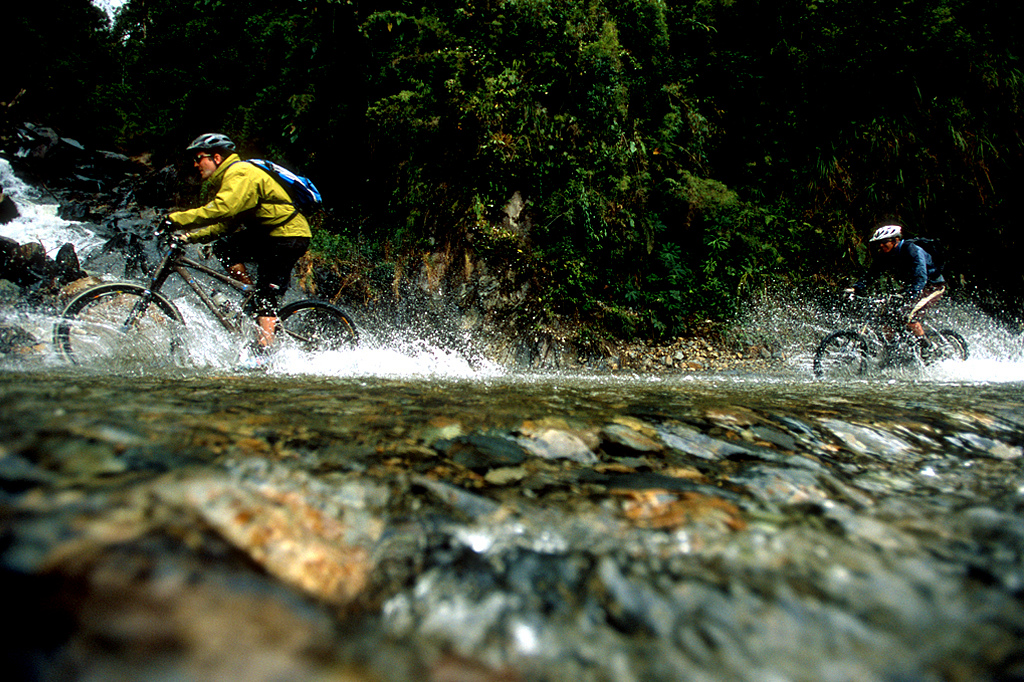 This was one of many river crossings we did. When we had an opportunity to jump out of the Van and onto the bikes we did. Might as well be shredding the road on your bike than in the vehicle.<br>You could imagine that this crossing is impossible at certain times of the year when that river in the upper left is raging.
