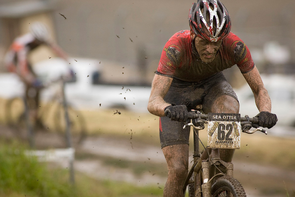 Guaranteed that there will be days where it is glorious sunshine minutes before start time, all the photo strobes are in place, and then a mighty sea-squall decides to keep the Norcal grass green. The veteran that knows Sea Otter will then bust out the 4 umbrellas, zip locks and rain wear and nail photos on lap one with clean atheletes, otherwise, everyone looks like Max Plaxton does here...