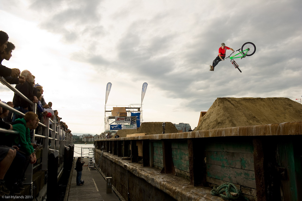 Luke Fulton with nice looking stretched out tailwhip on the second double on the barge.
