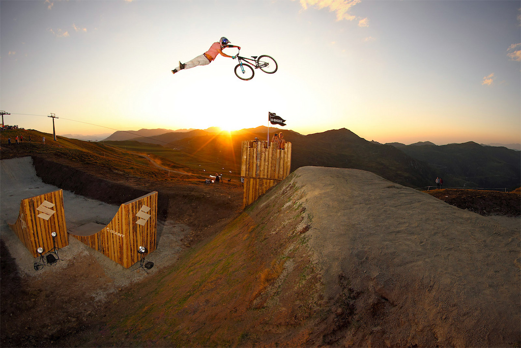 Martin pulls a huge superwhip over the Castle jumps at the 2011 Suzuki Nine Knights MTB event. Epic sundown session Make sure to watch it in high res photo c by www.larsscharlphoto.com me