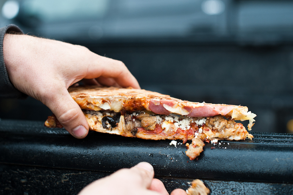 Greg Watts demonstrates the finer points of building a pizza sandwich.