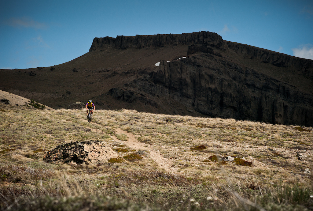 Big climbs up behind San Carlos de Bariloche bring you among enormous mesas and the start of long well-earned singletrack descents. Photo by Dan Milner.
